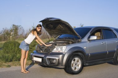 Brunette girl repairing the car clipart