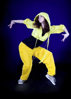 Teenage girl dancing hip-hop in the darkness clipart