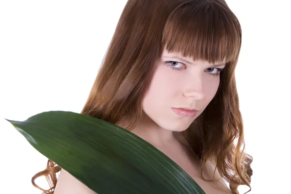 Woman hiding behind palm leaf — Stockfoto