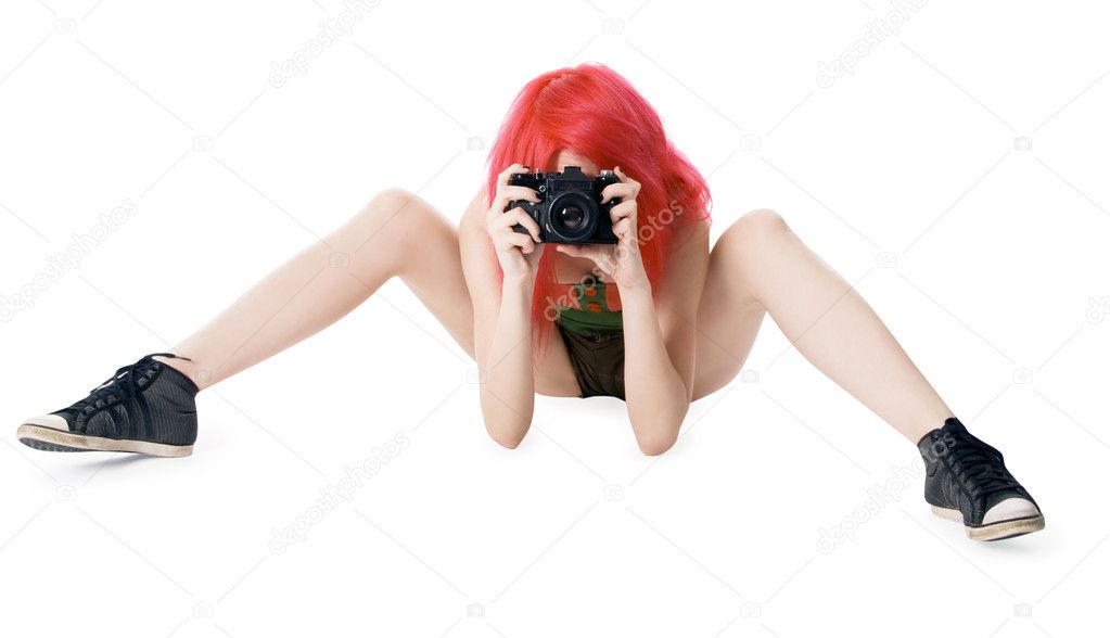 Red-hair young girl with photocamera isolated on white