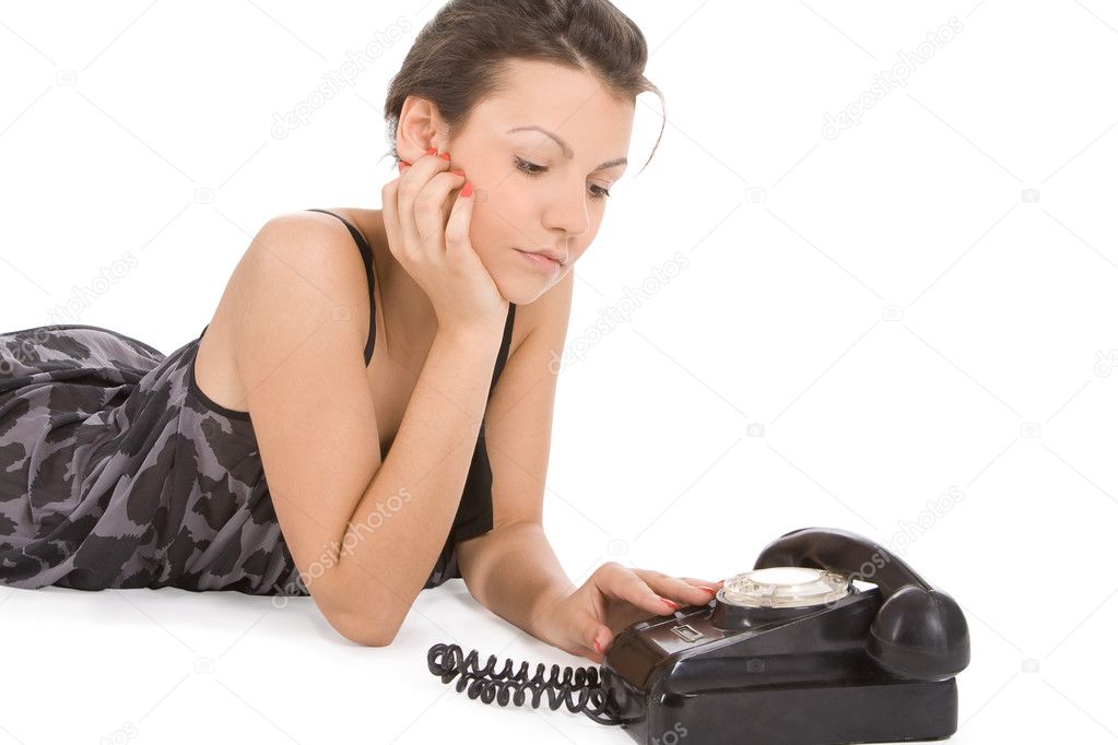Young woman looking at old phone