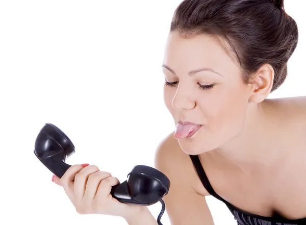 Brunette showing tongue to phone — Stock Photo, Image