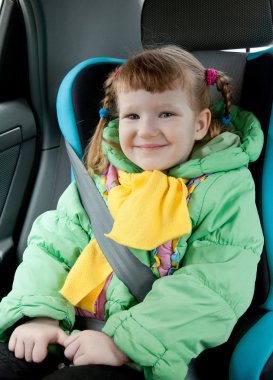 Cute little girl in a car clipart