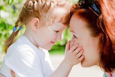 Young mother and her cute little daughter clipart