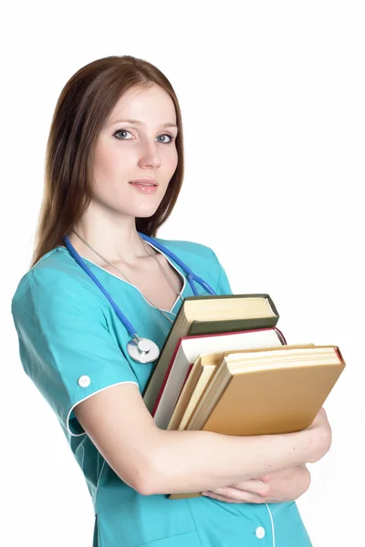 Πορτρέτο του σοβαρή γυναίκα γιατρό στην πράσινη ομοιόμορφο με βιβλία — Φωτογραφία Αρχείου