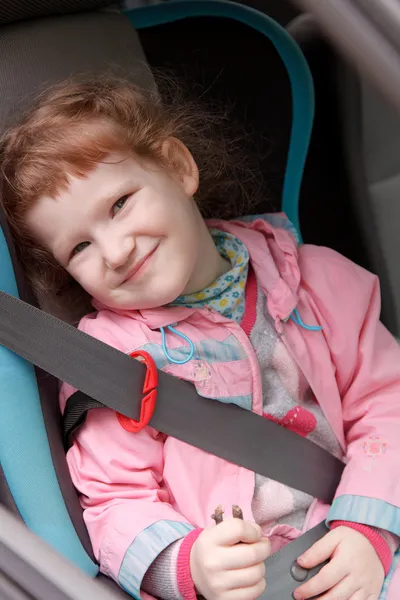 Cute little girl in a baby car seat — Stock Photo, Image