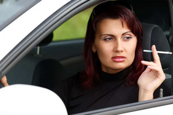 Woman sitting in a car — Stock Photo, Image