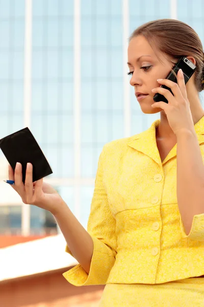 Uma mulher de negócios bonita falando ao telefone no prédio de escritórios — Fotografia de Stock