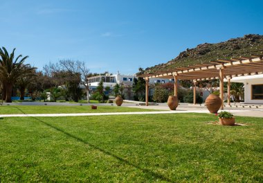 Green lawn in the courtyard of hotel clipart