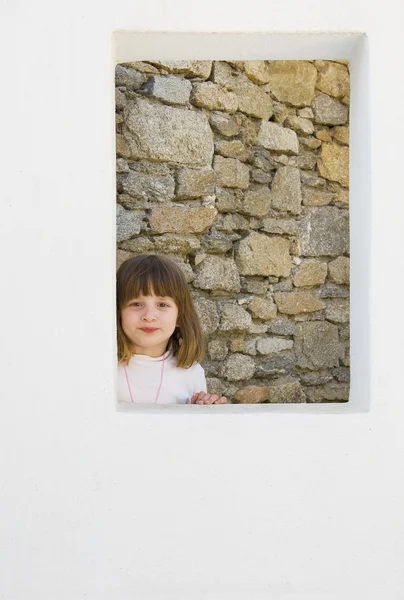 stock image A small child in the window