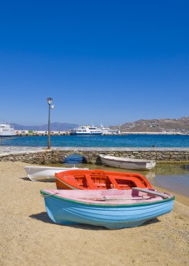 Fishing boats on sandy beach clipart