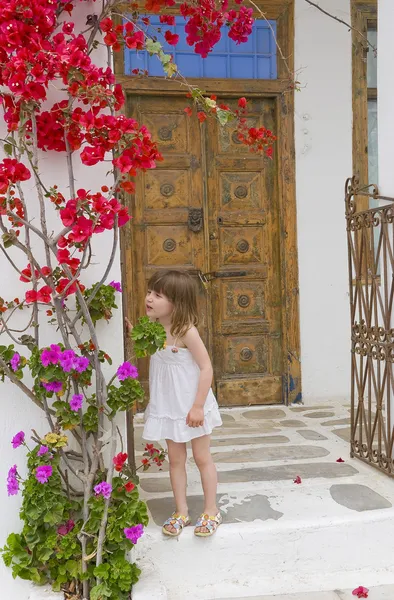 stock image Little girl smelling the flowers