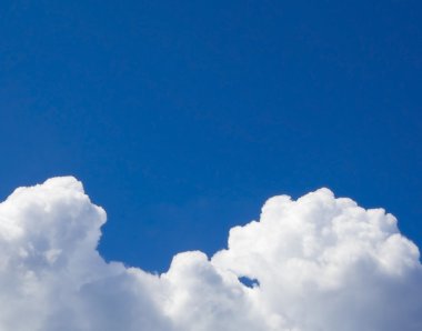 A blue sky and white cumulus clouds on it clipart