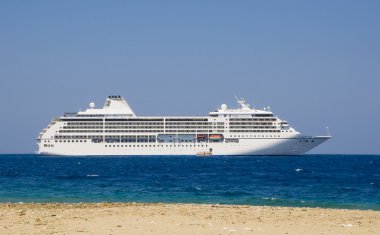 Large cruise ship in the blue sea clipart