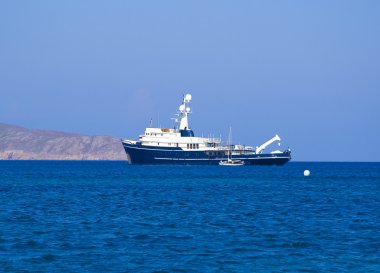 Blue ship in the sea is at anchor clipart