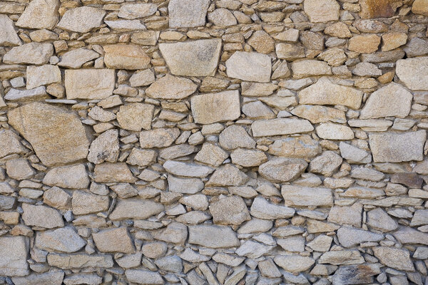 A wall of rough untreated wild stone. background texture...
