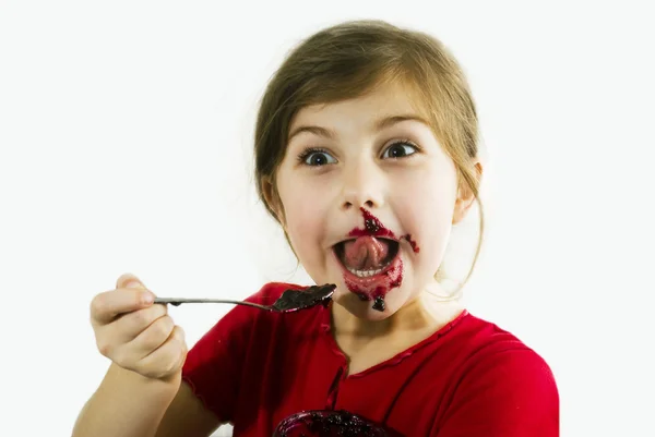 Het meisje eet BES jam — Stockfoto