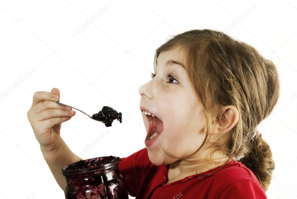 The girl eats currant jam