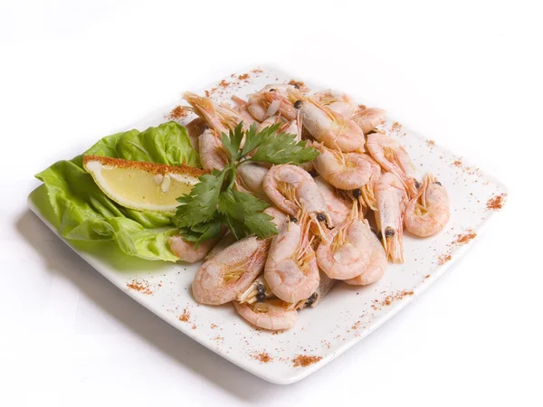 Boiled shrimps with salad leaves and slice of le Royalty Free Stock Photos