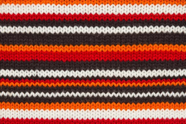 Tejer la textura del jersey. hilos anaranjados, blancos y negros — Foto de Stock