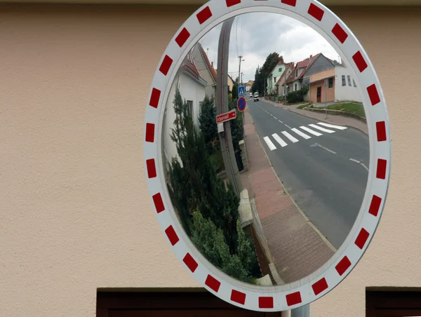 stock image Mirror by the road for drivers to see behind the