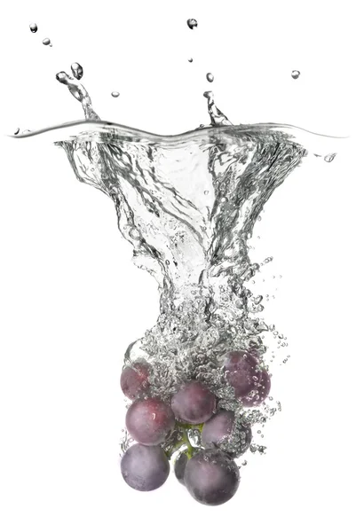 Blue grape dropped into water — Stock Photo, Image