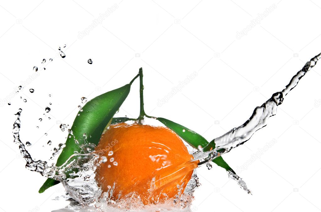 Tangerine with green leaves and water