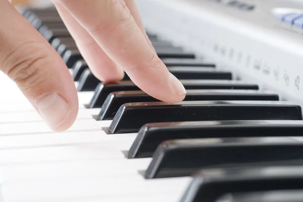 Hand playing music on the piano — Stock Photo, Image