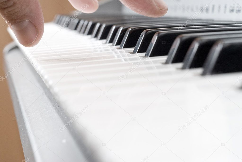 Hand playing music on the piano