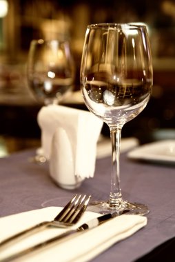 Wineglass on served table in restaurant clipart