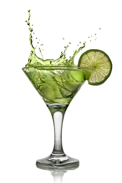 Green alcohol cocktail with splash and green lime — Stock Photo, Image