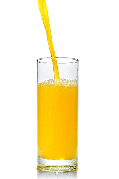 Orange juice poring into glass — Stock Photo, Image