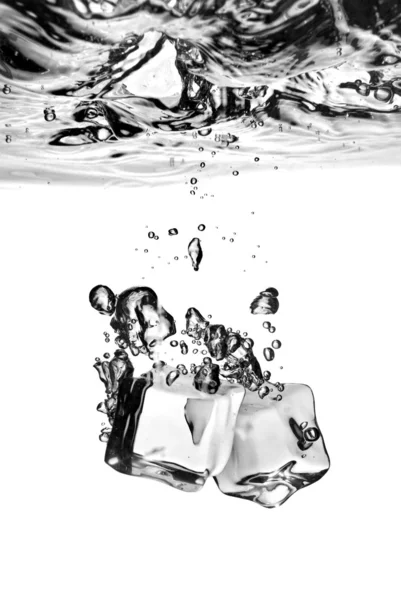 Cubos de hielo arrojados al agua con salpicaduras — Foto de Stock