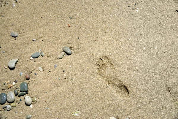 Sand stones with footprint — Stock Photo, Image
