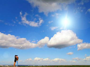 Couple against blue sky clipart