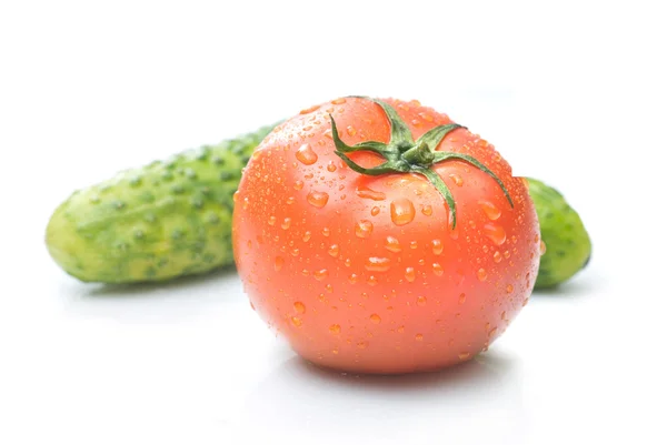 Red tomato and green cucumber with water drops — Stock Photo, Image