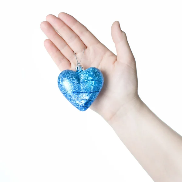 Arm holding blue christmas ball in shape of heart — Stock Photo, Image