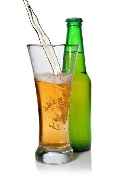Beer pouring from into glass isolated with bottle — Stock Photo, Image