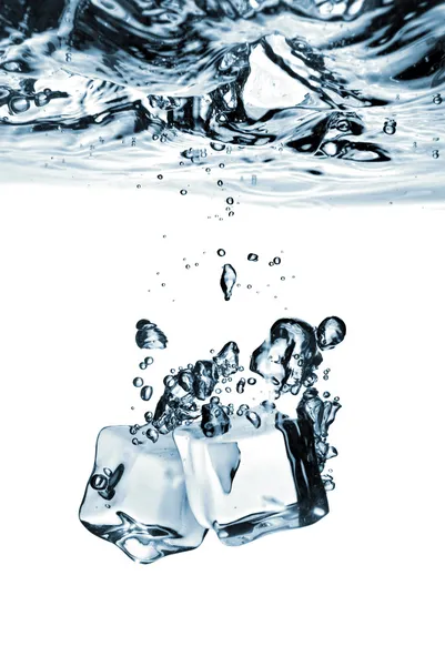 Ice cubes dropped into water — Stock Photo, Image