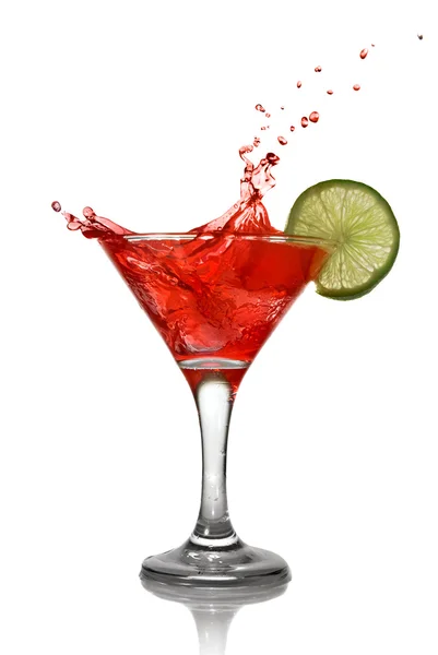 Red cocktail with splash and lime — Stock Photo, Image