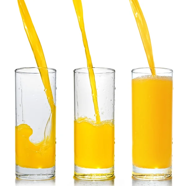 Orange juice poring into glass — Stock Photo, Image
