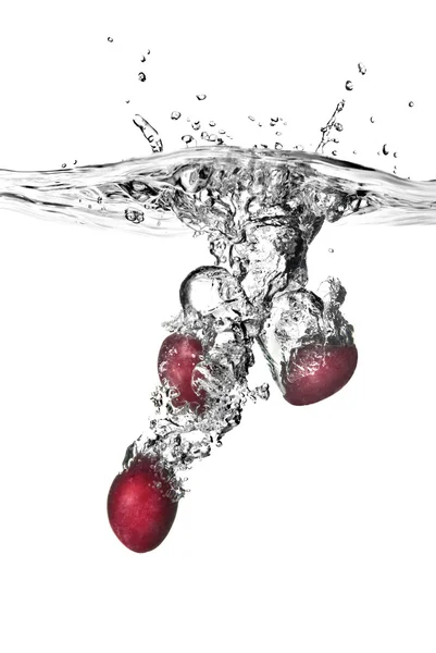 Plum dropped into water with bubbles — Stock Photo, Image