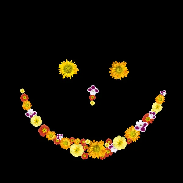 Декоративний символ посмішки з кольорових квітів — стокове фото