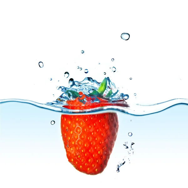 Φρέσκια φράουλα πέφτει σε μπλε νερό με splash απομονώνονται σε λευκό — Φωτογραφία Αρχείου