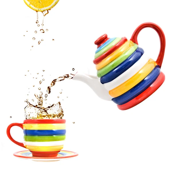 stock image Color teapot with cup and lemon isolated on white