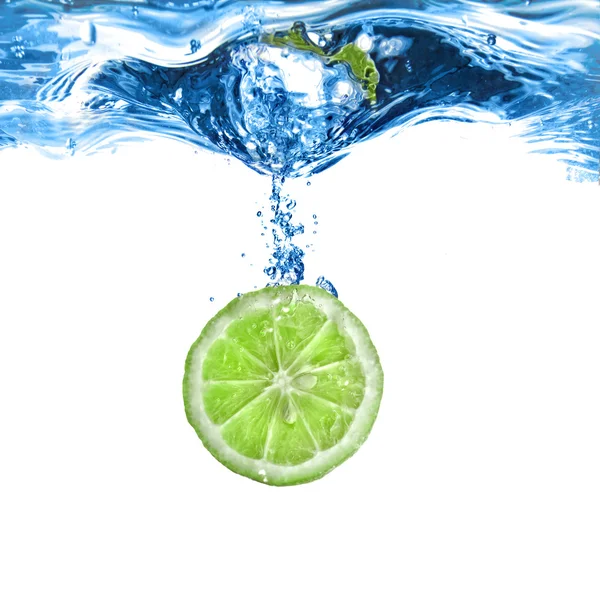 Fresh lime dropped into water with bubbles isolated on white — Stock Photo, Image