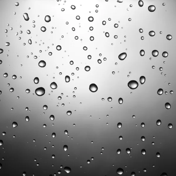Droppar vatten på glas — Stockfoto