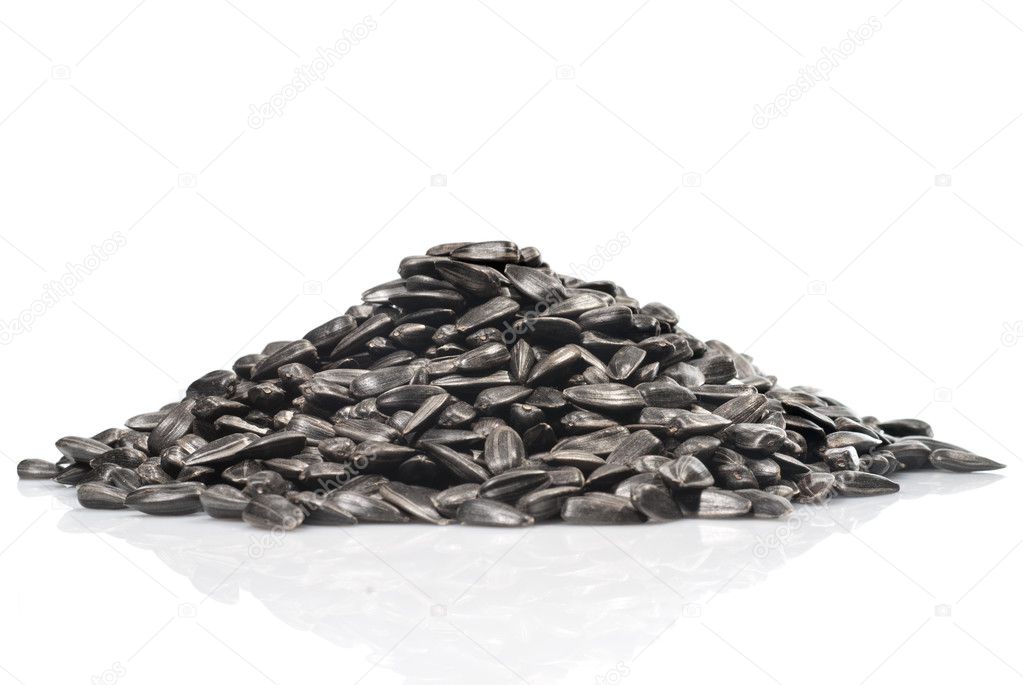 Pile of black sunflower seeds isolated on a white background