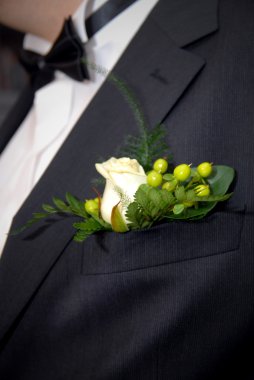 Wedding buttonhole with rose on mans suite clipart