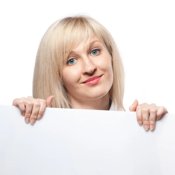 Smiling woman holding white empty paper — Stock Photo, Image